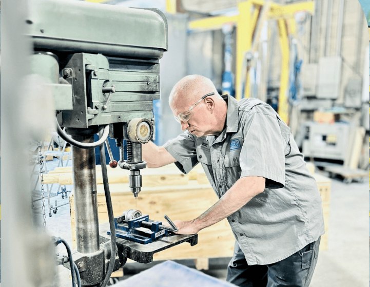 Walter Kaczynski servicing industrial machinery as a RACO technician